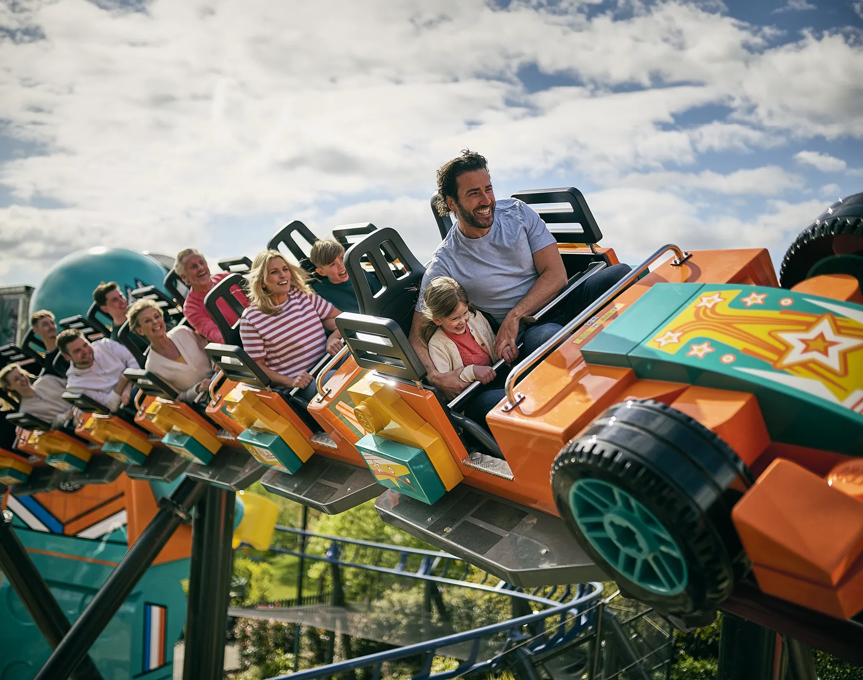 Families smiling and laughing while on the Minifigure Speedway rollercoaster at the LEGOLAND Windsor Resort