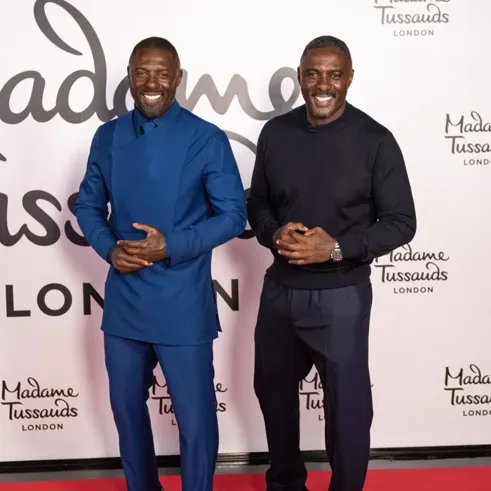 Two men standing in front of a wall

AI-generated content may be incorrect.