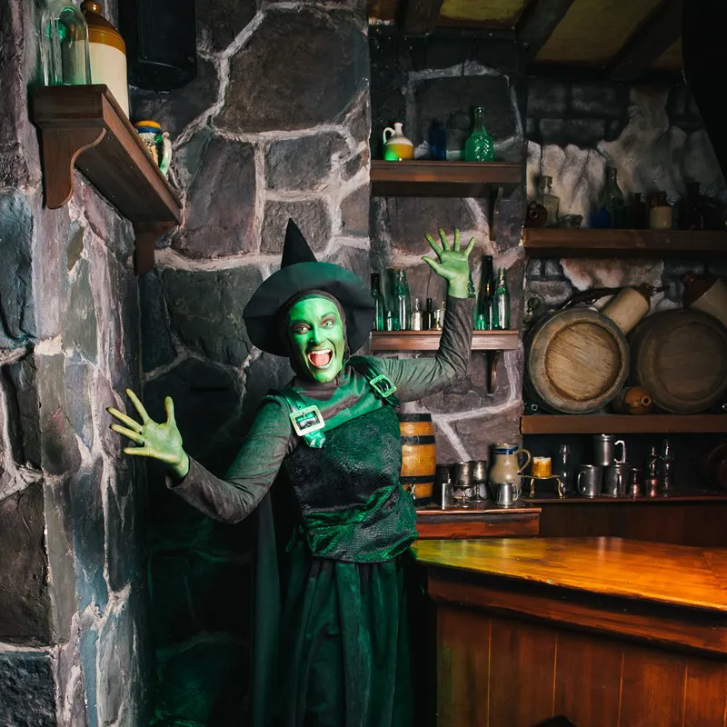 Witch in Poison Apple Pub during Halloween at Shrek's Adventure! London