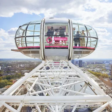 Families looking out on the London skyline from a pod on The London Eye