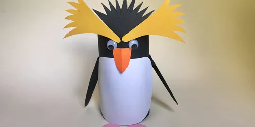 How to Create a Penguin Step 6: Finally, glue the yellow top feather shapes and black feather shape to the penguin.