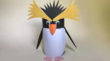 How to Create a Penguin Step 6: Finally, glue the yellow top feather shapes and black feather shape to the penguin.