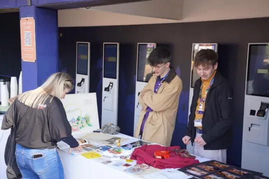 A group of people looking at a table

AI-generated content may be incorrect.