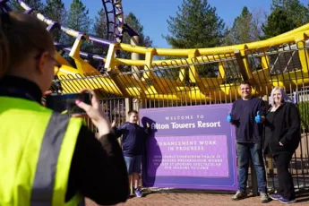 A group of people taking a picture of a roller coaster
AI-generated content may be incorrect.