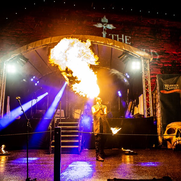 Man breathing fire at Castle After Dark at Warwick Castle