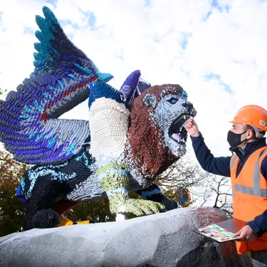 Adding finishing touches to Chimera LEGO Model in LEGO MYTHICA at the LEGOLAND Windsor Resort